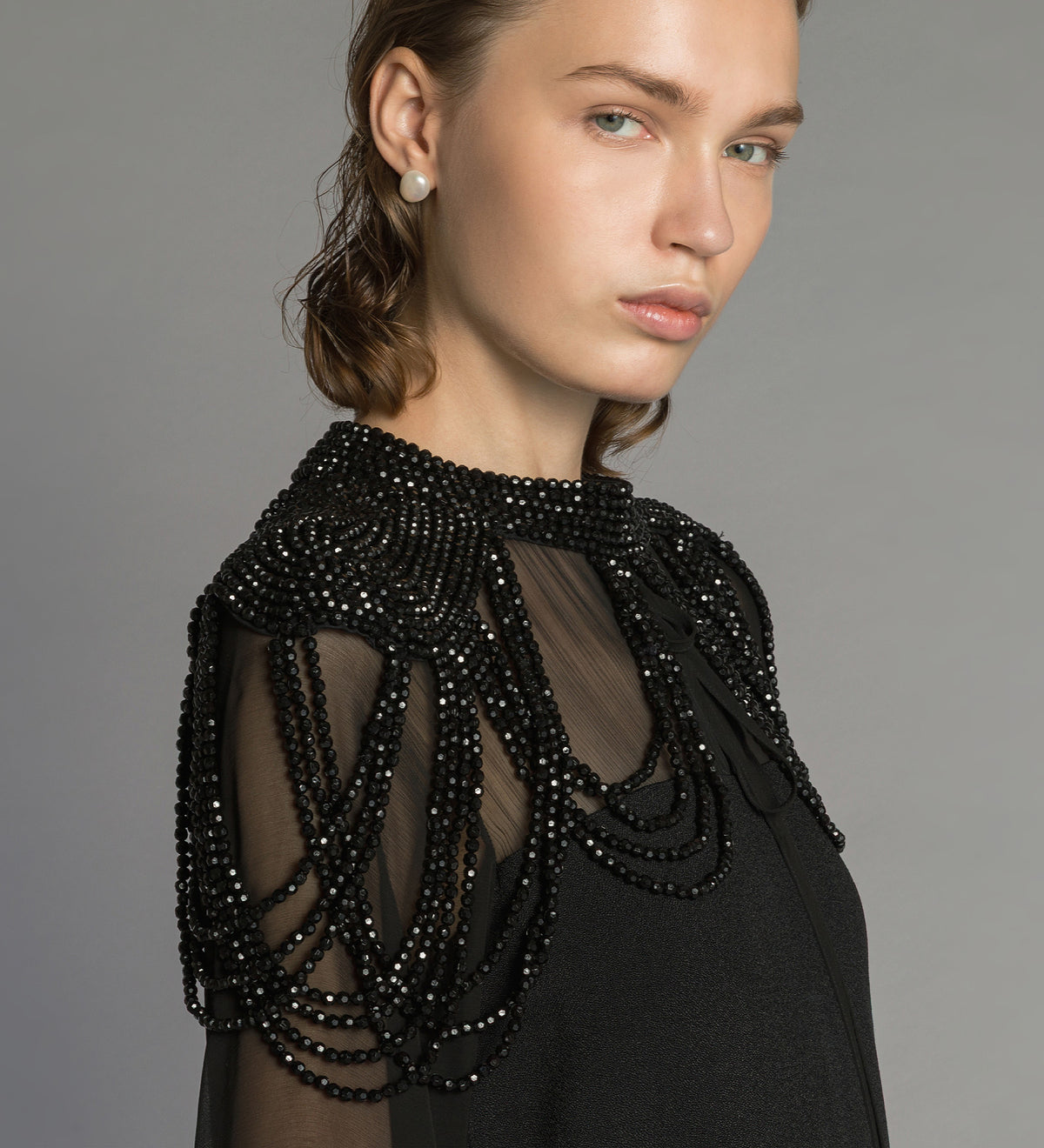cape with hand-embroidered “black diamond” pearls black diamond
